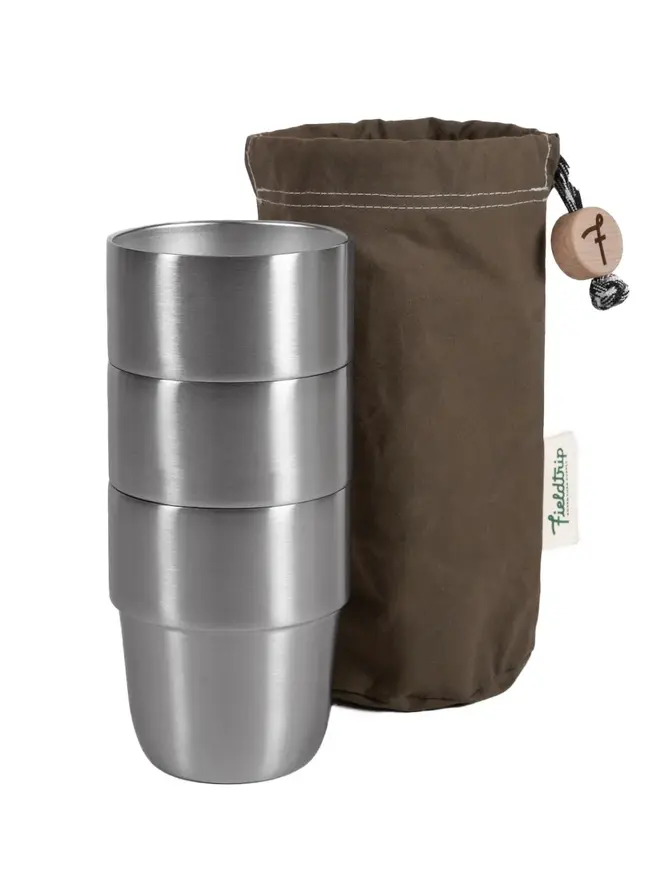 3 stainless steel cups next to an olive storage bag
