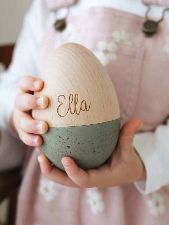 Large wooden hollow egg in sage with the name Ella