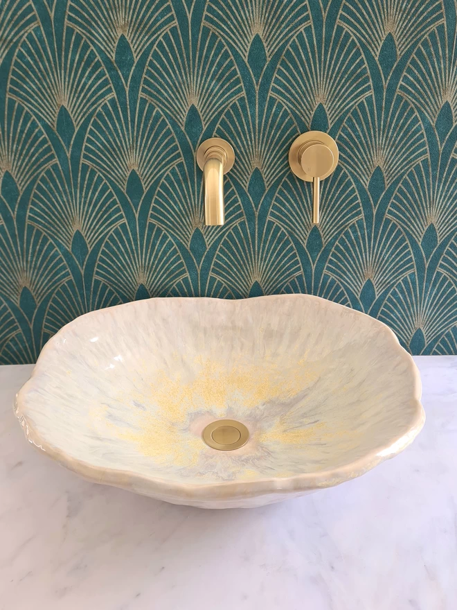 Ceramic bathroom basin, hand-crafted basin, sink, wc, bathroom, ensuite, modern bathroom, photographed against colourful green art deco wallpaper with gold taps