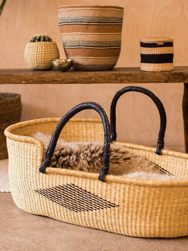 black diamond moses basket styled with other natural baskets