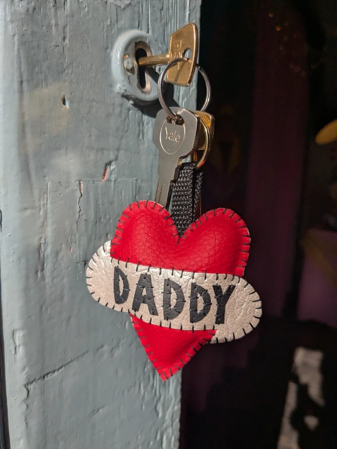 Red tattoo style leatherette heart keyring with the word Daddy