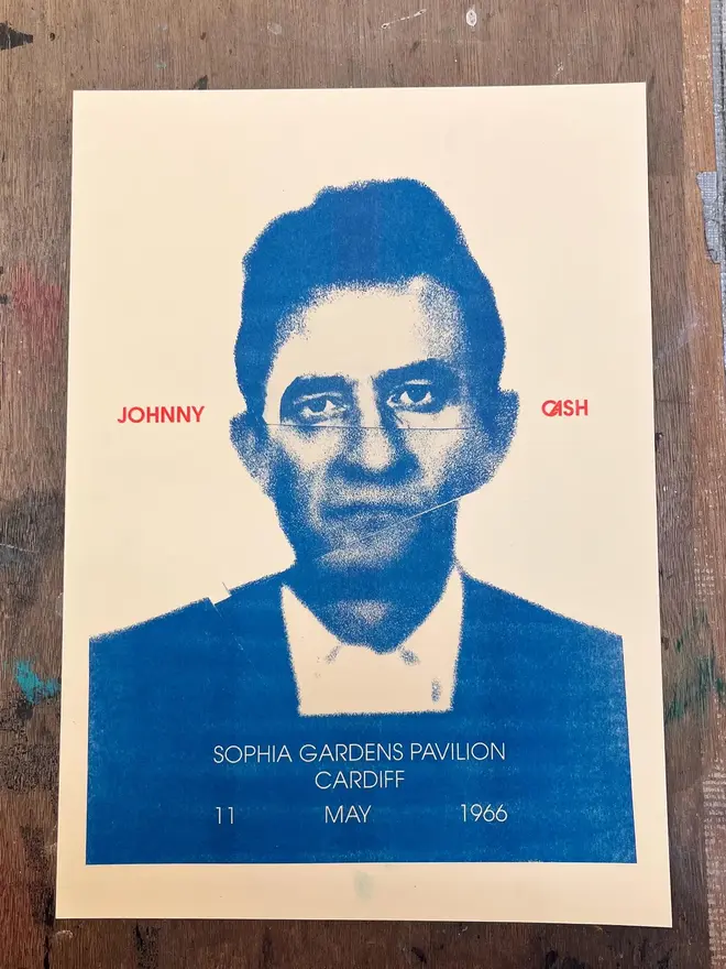 'Johnny Cash' Handmade Risograph Gig Poster, laying on a wooden table. 