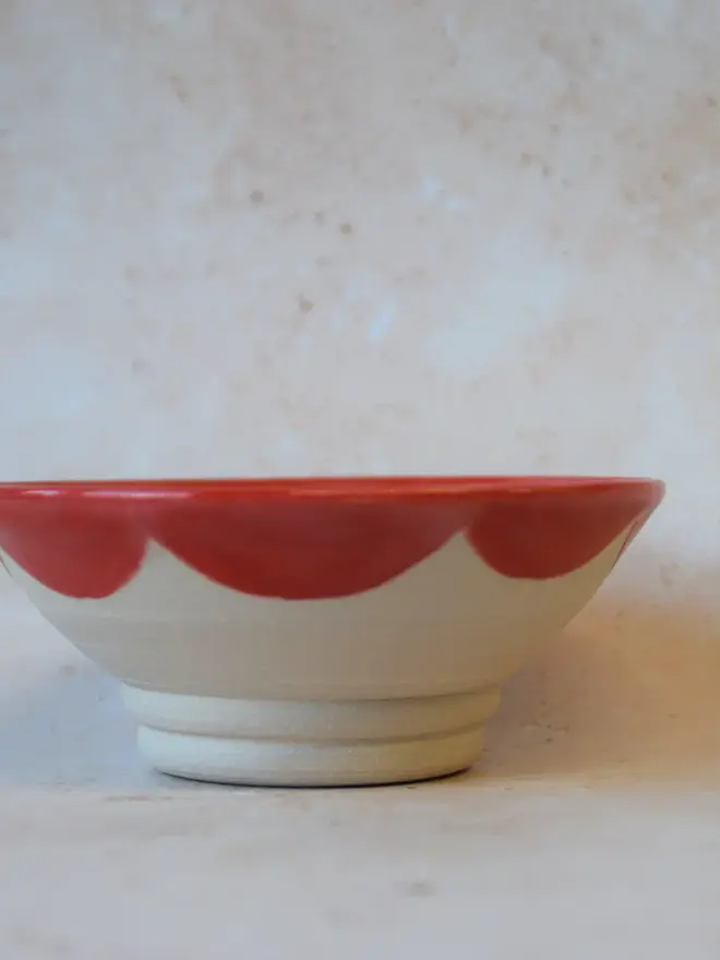 Handmade scalloped edge trinket dish - side view showing red  scalloped pattern