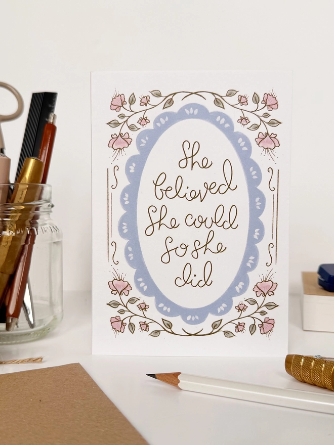 'She Believed She Could So She Did' Card on desk