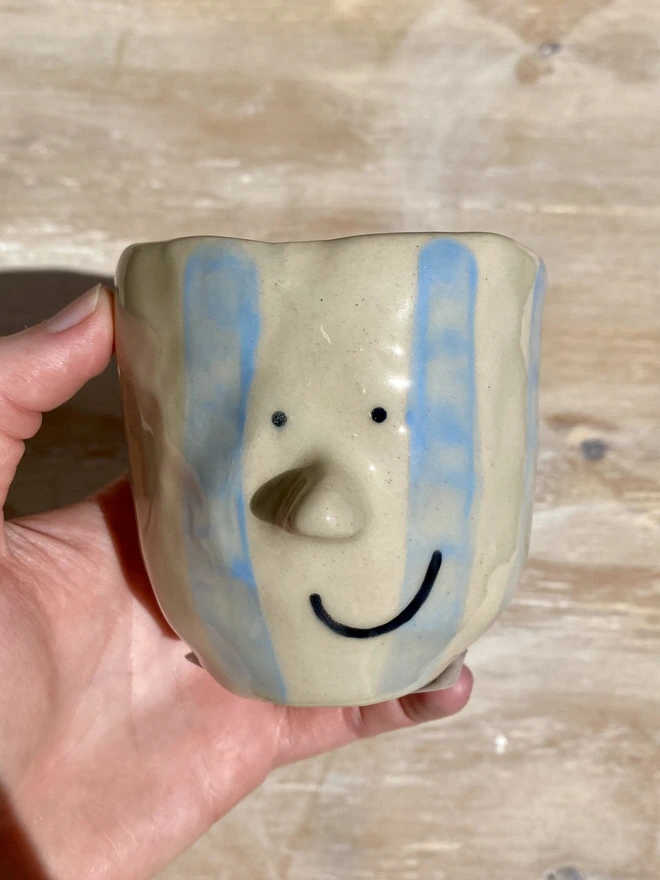 blue stripe pot - held