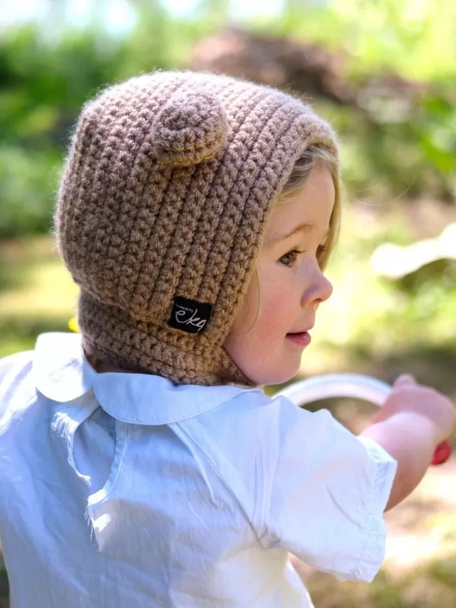 EKA Animal Bonnet seen on a child on a bicycle.