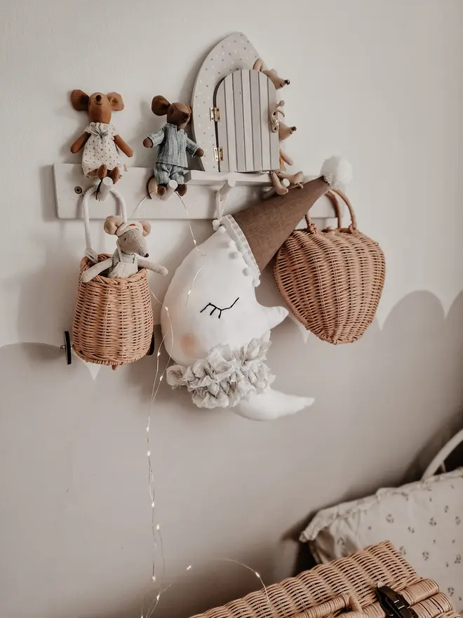 Hanging Moon Pillow Decoration, a hanging moon pillow decoration suspended from a shelf amongst other bedroom decoration items. 