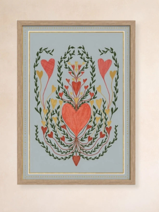 Love In Blue Art Print, a colourful print hanging on a wall. It has a heart motif. 