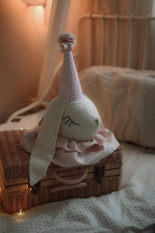 Rabbit Head Wall Mount, a cotton rabbit head wall decoration in a child's bedroom accompanied by other bedroom accessories. 