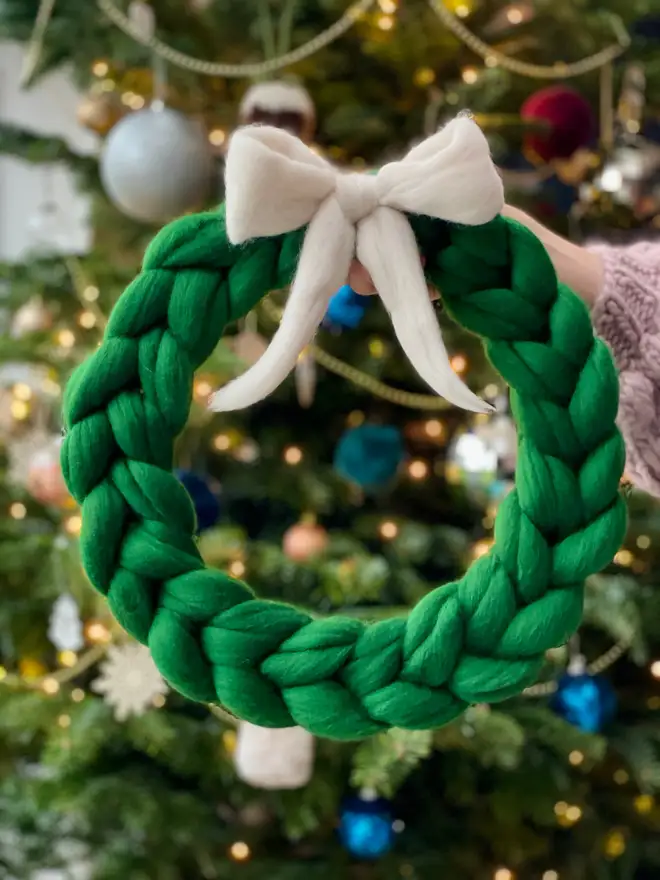 forest green woolly wreath with red bow