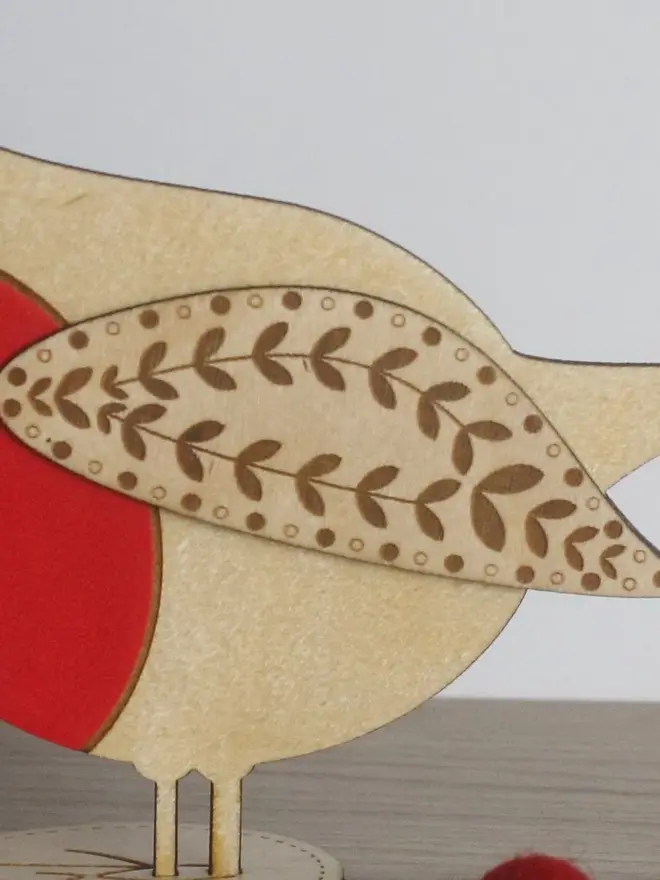 Standing Wooden Robin, red wooden bird decoration standing on a platform. 