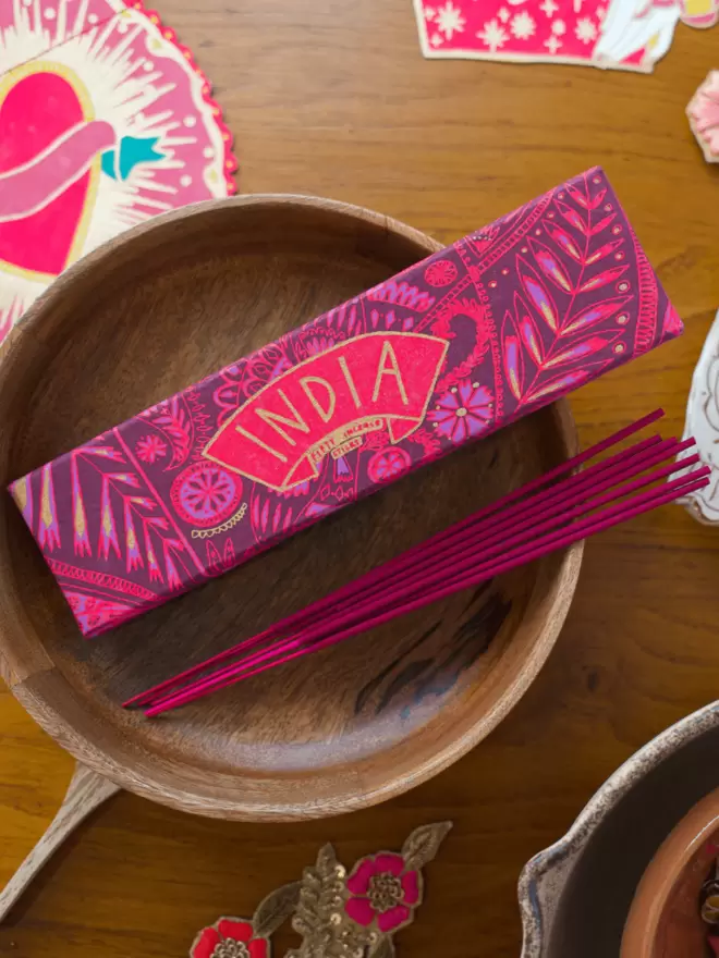 Close-up, detailed shot: pink India box with matching pink incense sticks 