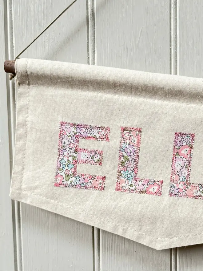 Personalised Name Banner.  Part of a banner displaying pink floral letters to spell the name ELLE 