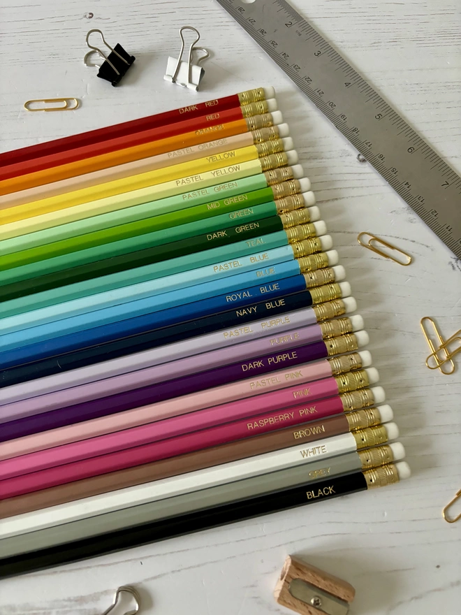 Rainbow HB Pencils laid out on a desk