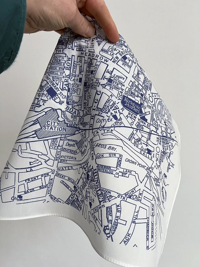 A white hand holds a Leeds Map Handkerchief
