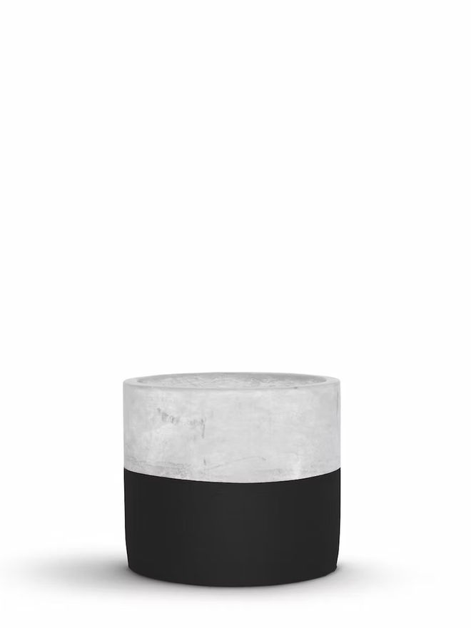 half full concrete plant pot. a grey concrete plant pot with the bottom half painted black.