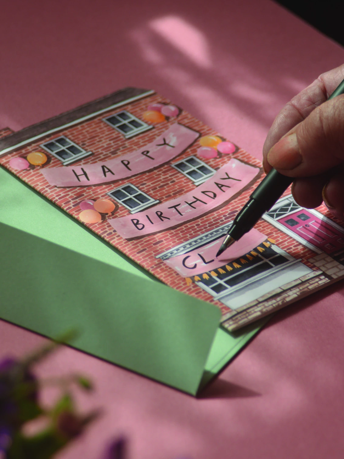 House shaped card being personalised.