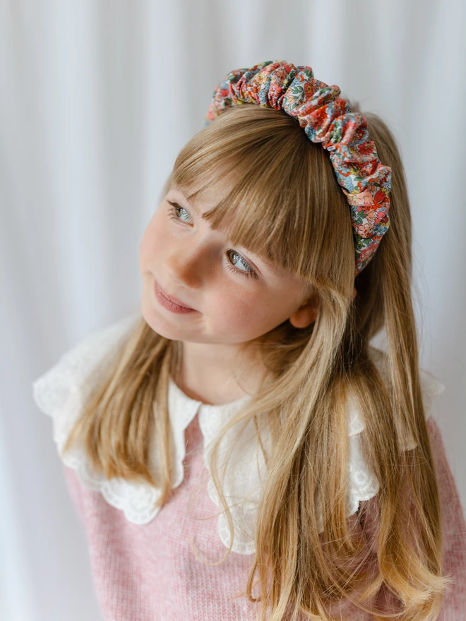 Grils wearing her liberty scrunchie style ruffled hairband alice band