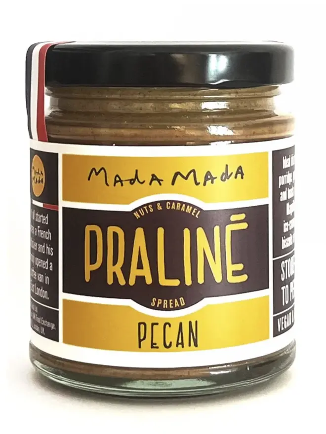jar of pecan praline nut butter, with yellow label and black lid
