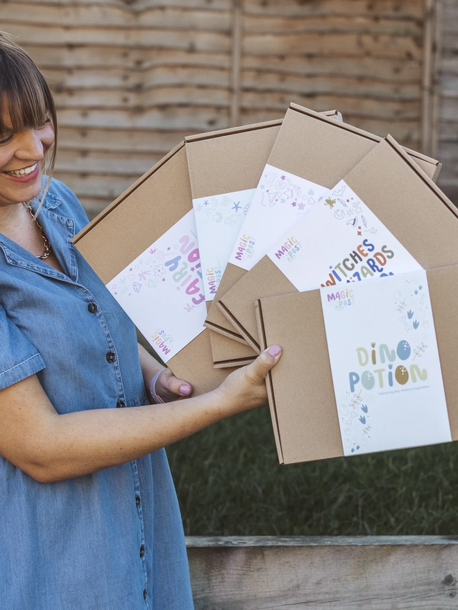 Kirsty holding all potion kits outside