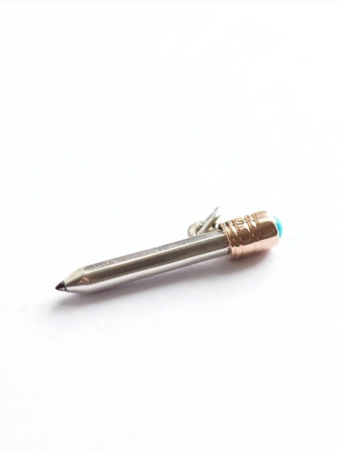 Dinky Pencil Charm. A pencil charm against a plain background.