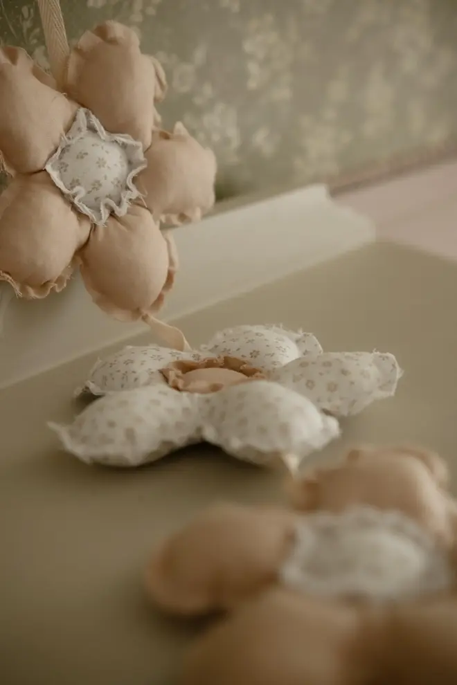 Daisy Flower Garland Decoration, a hanging colourful daisy flower garland sitting in a child's bedroom. 