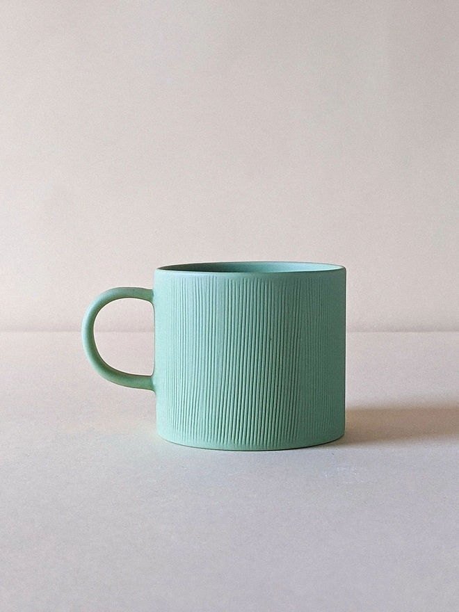 Small Porcelain Coffee Cup in Pale Rockpool Green with Hand Carved Combed Texture