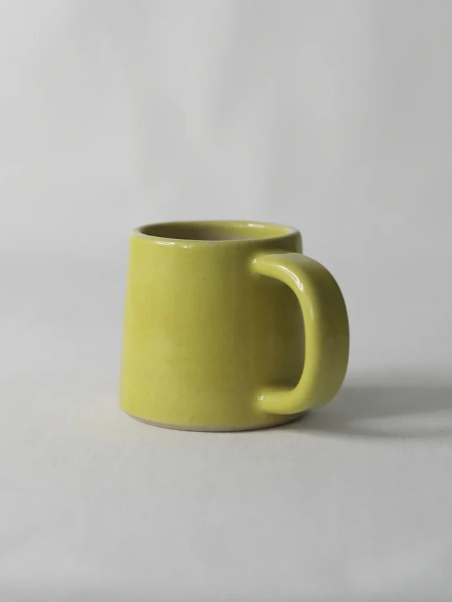 Classic Ceramic Espresso Mug, a colourful ceramic espresso mug sitting on a plain surface against a white backdrop. 
