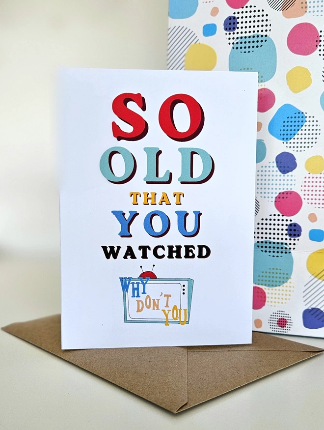 A nostalgic card that says So old that you watched Why Don't You in colourful retro style fonts on a white background with an illustration of a TV with the words Why Don't You written in a similar way to the programmes TV titles.