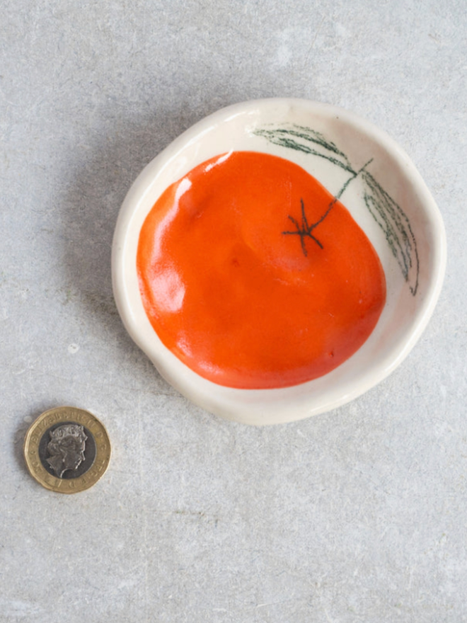 Wee Dishes. A dish with an orange design.