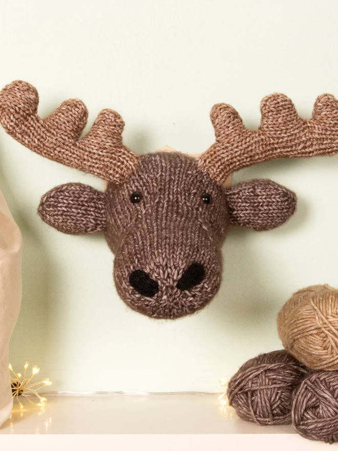 Mini Moose Head Knit Kit. A moose head mounted on a wall.