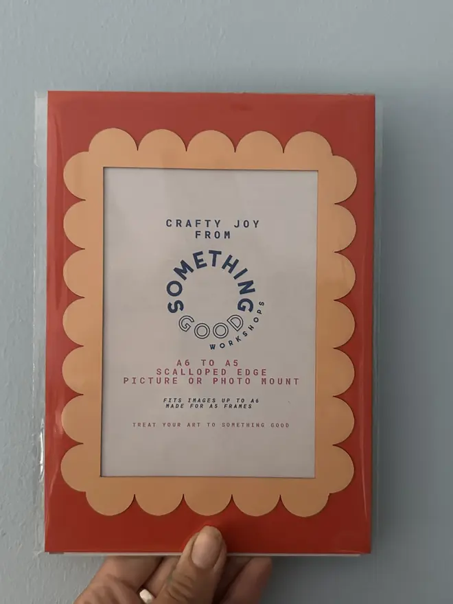 Scallop Edged A5 / A4 photo mount. red and orange variant held against grey background.