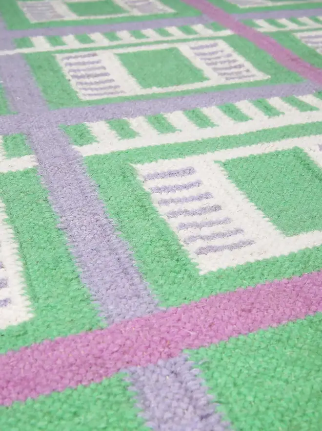 Labourdonnais Flatweave Rug, a colourful rug sitting on a plain surface. 