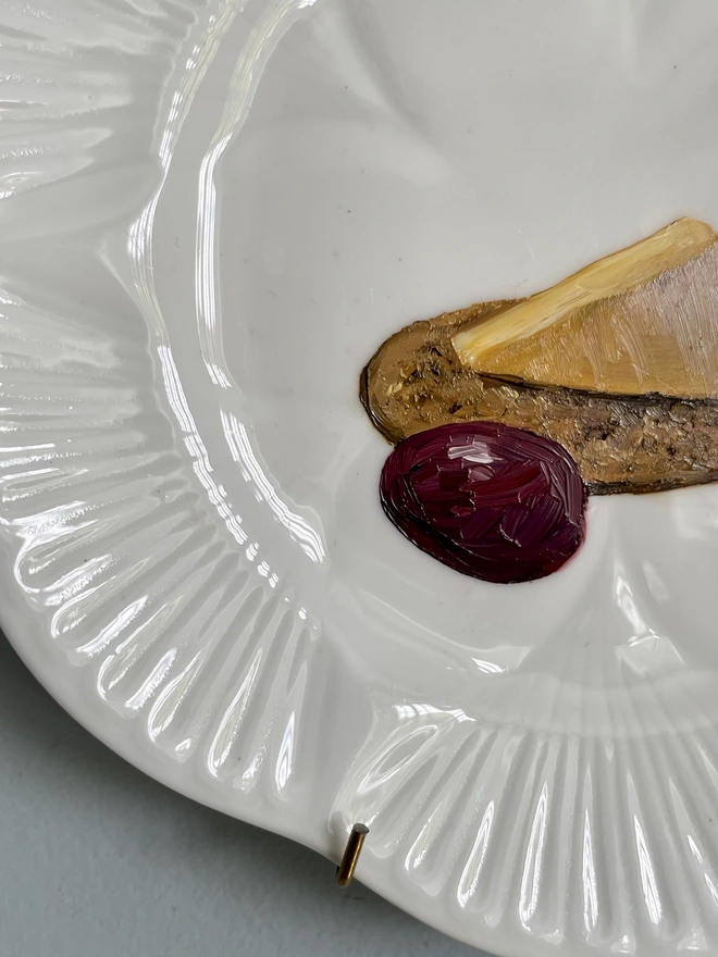 detail of cheese painting on plate