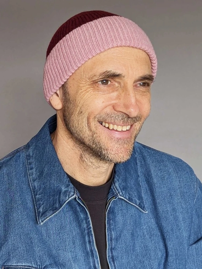 Ribbed Lambswool Unisex Beanie, a person wearing a colourful ribbed beanie outdoors. 