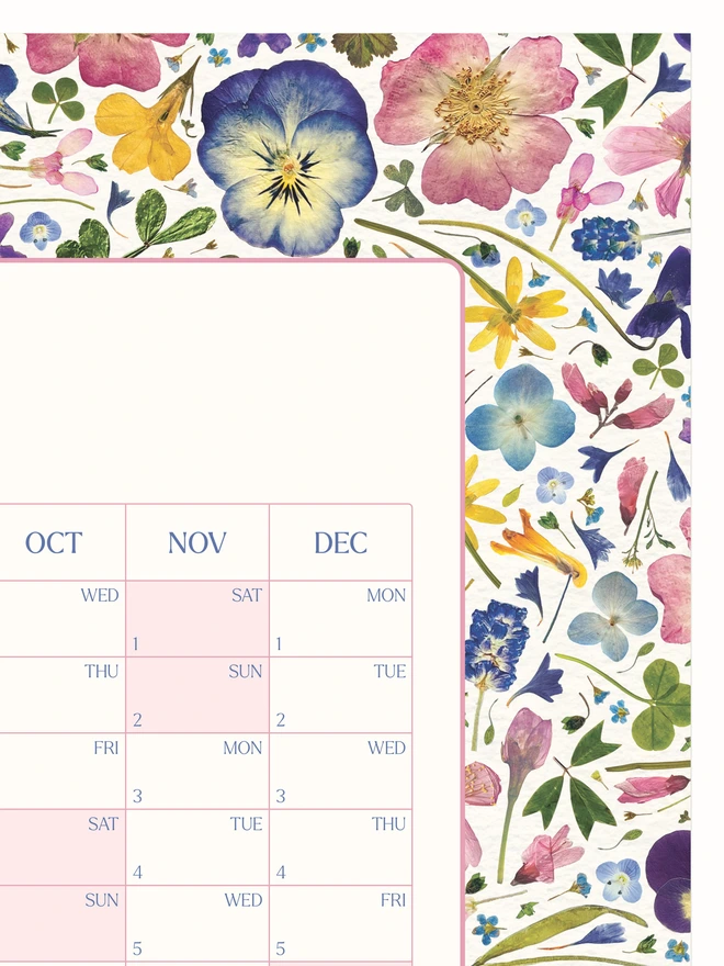 Close-up of a nature inspired wall calendar. A 2025 wall planner with a pretty pressed flower design. Makes a thoughtful home planning or organisational gift or Christmas or birthdays.