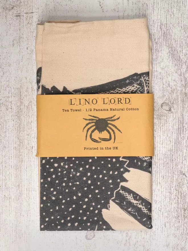 Picture of a tea towel with an image of a spider crab, taken from an original lino print