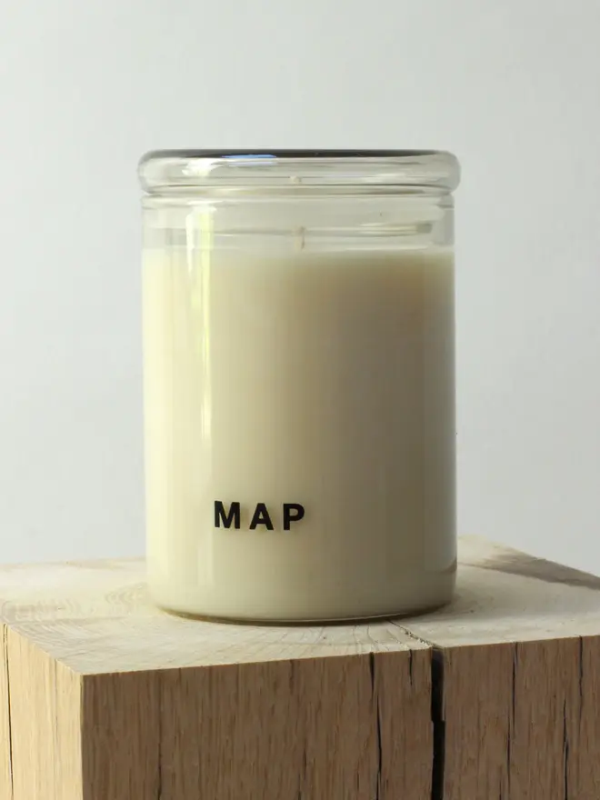 sunbeam clary sage and bergamot soy candle. candle placed on wooden surface. 