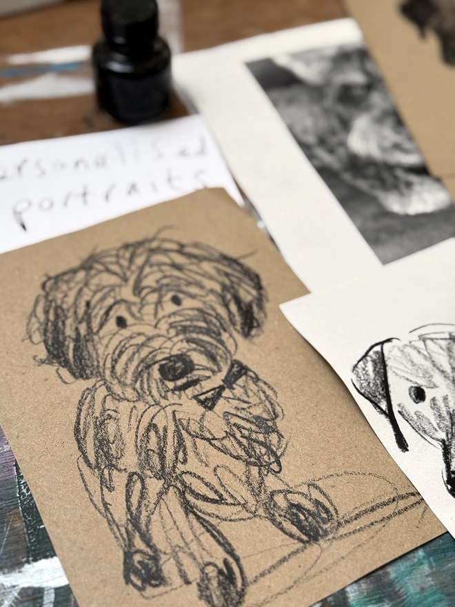drawings of dogs on brown paper on a drawing board