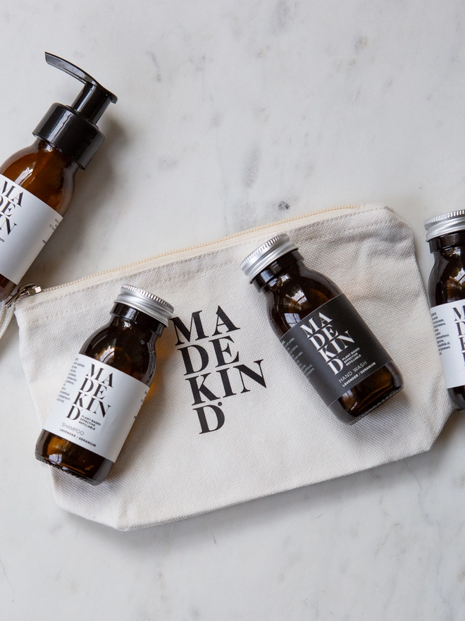 MadeKind Wash Bag with toiletries in amber glass bottles