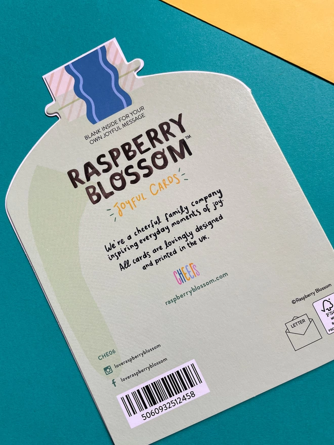 The reverse of the die cut gin shaped birthday card has a small blurb about Raspberry Blossom, a cheerful family company inspiring everyday moments of joy