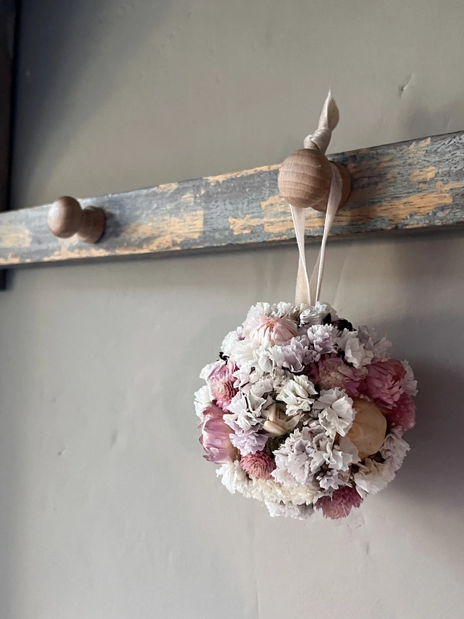 Pink and white dried flower bauble made using a selection of seasonal blooms. 