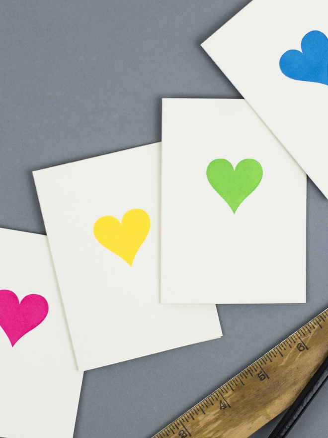 An image of the four neon heart designs which are neon pink, blue, yellow and green