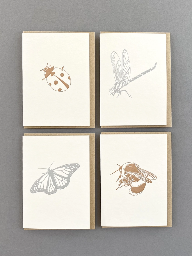 Image of the four metallic insect designs on small cards with all elements being 100% recycled and recyclable