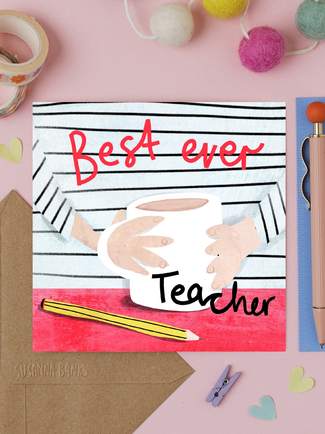'best ever teacher' illustrated card. card photographed on table with assorted craft items.