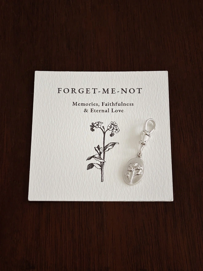 Forget me not medal charm on a albert swivel clasp and folklore card