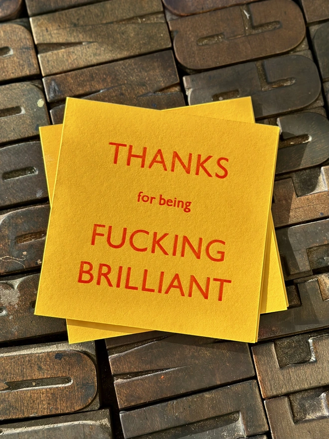 Thanks for Being Fucking Brilliant card letterpress printed yellow card on wooden type background