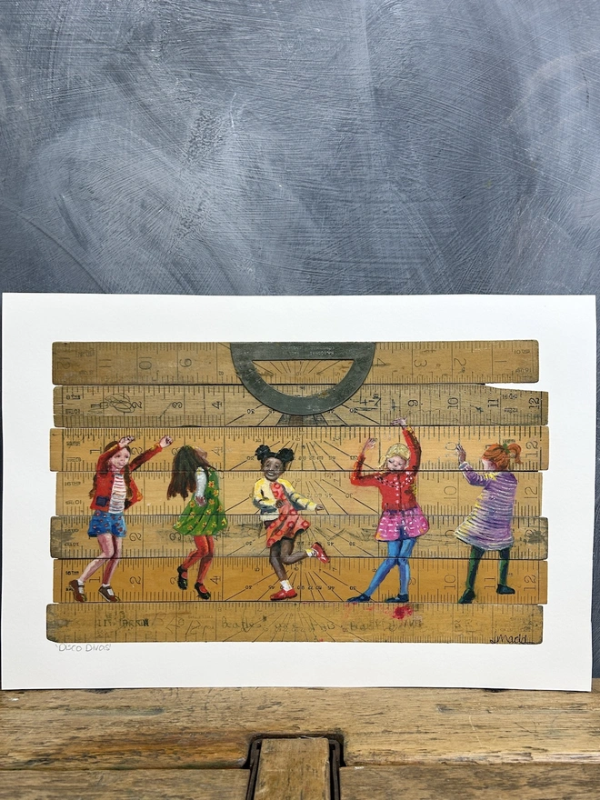 little girls dressed in bright colours, dancing, painted on to vintage school rulers