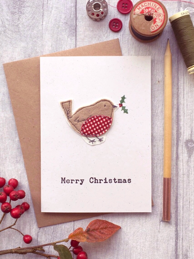 Freehand embroidered Robin with hand painted holly on a recycled letterpress card