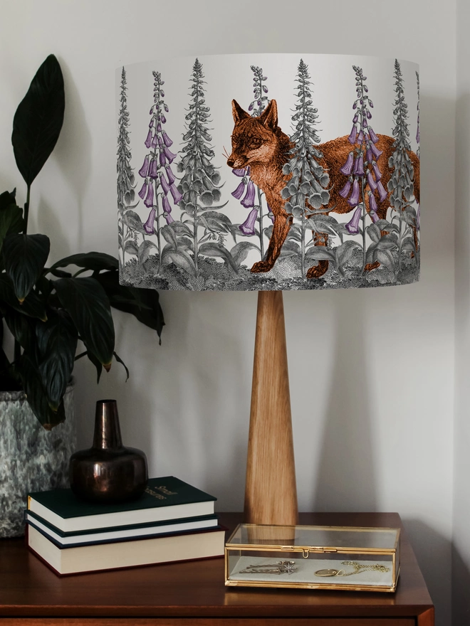 Handmade lampshade featuring a mischievous fox moving through foxglove flowers in a whimsical woodland design.